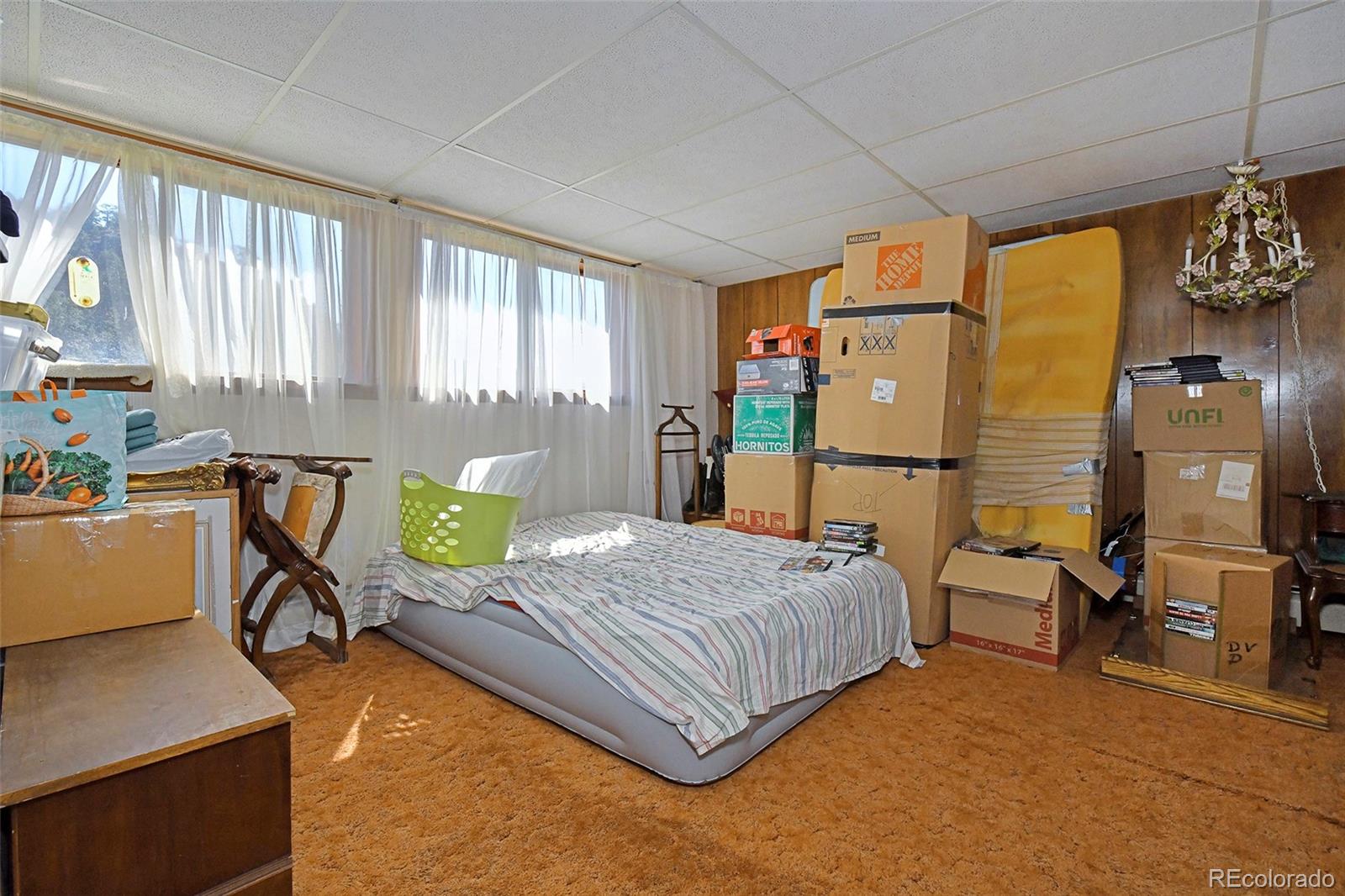 79 Ranch View Drive Florissant, CO 80816 - Photo 17 of 40 a bedroom with a bed and wooden floor