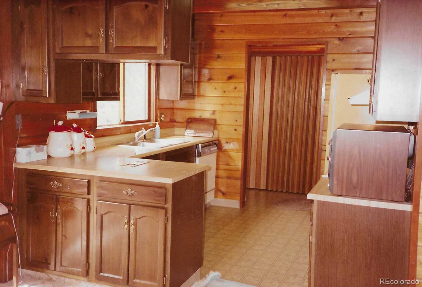 79 Ranch View Drive Florissant, CO 80816 - Photo 19 of 40 a kitchen with a sink and a refrigerator