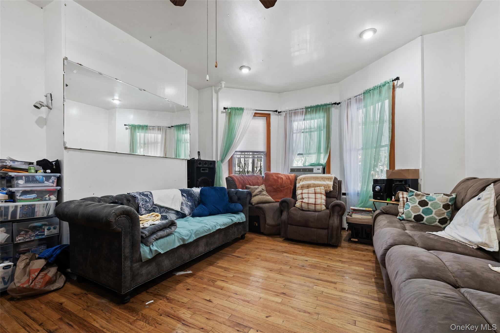 3158 Decatur Avenue Bronx, NY 10467 - Photo 5 of 7 a living room with furniture window and a wooden floor