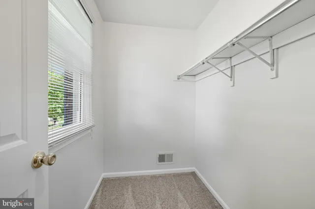 a view of a room with rack on the wall and a window