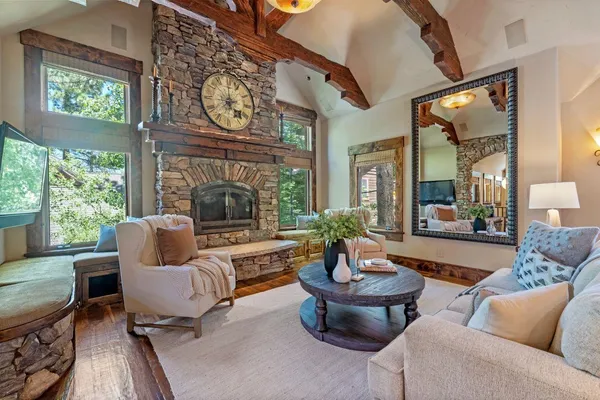 a living room with furniture a fireplace and a large window