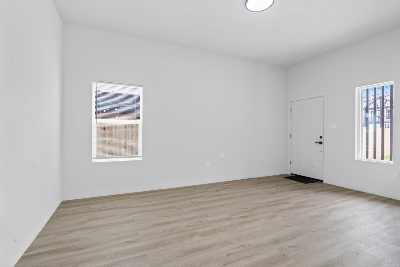 9725 Kerr Street, Unit A Houston, TX 77029 - Photo 6 of 34 Bright open living area with fresh neutral finishes, wide-plank flooring, recessed lighting, and windows that bring in natural light for an airy everyday space.
