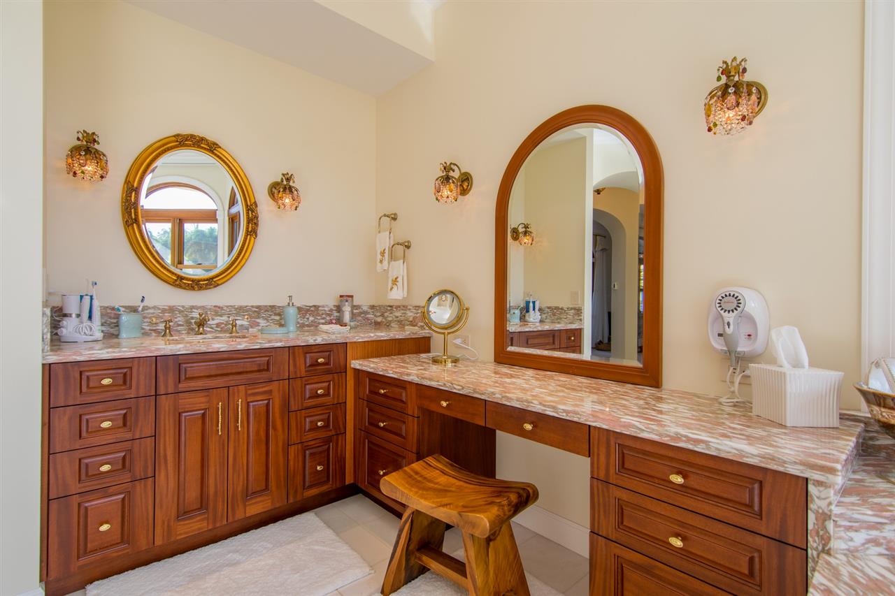 80 Hale Pili Way Haiku, HI 96708 - Photo 23 of 30 a bathroom with a granite countertop sink a mirror and a window