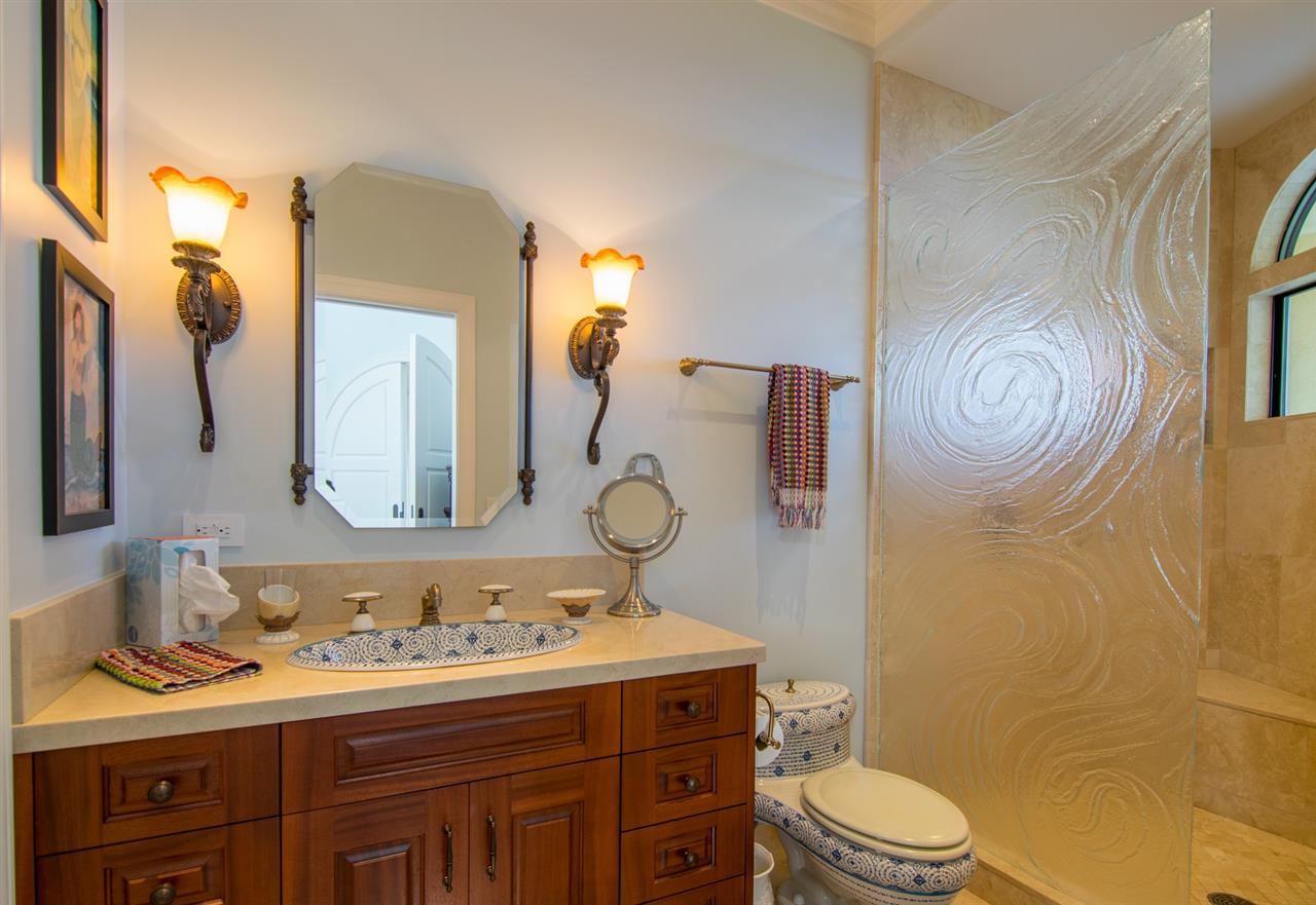 80 Hale Pili Way Haiku, HI 96708 - Photo 26 of 30 a bathroom with a granite countertop toilet sink and mirror