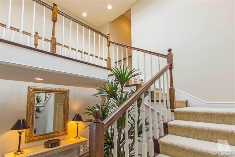 2238 Canyonback Road Los Angeles, CA 90049 - Photo 22 of 43 a view of staircase with lots of frames on wall and a window