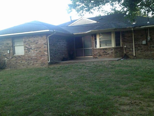 4909 Neely Road Memphis, TN 38109 - Photo 4 of 20 a view of a brick house with a yard