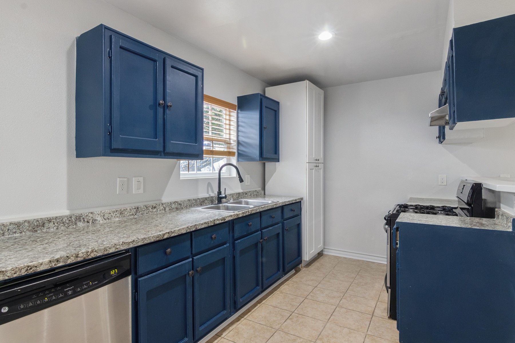 4505 Cochran Street Houston, TX 77009 - Photo 6 of 25 a kitchen with a sink and cabinets