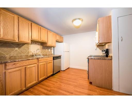 97 Burnham Road Lowell, MA 01852 - Photo 8 of 14 a kitchen with granite countertop cabinets stainless steel appliances and a window