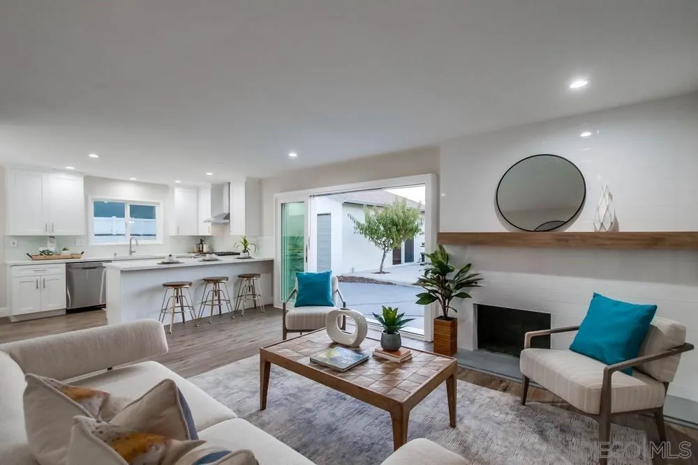 4534 Kamloop Avenue San Diego, CA 92117 - Photo 15 of 36 a living room with furniture kitchen view and a wooden floor