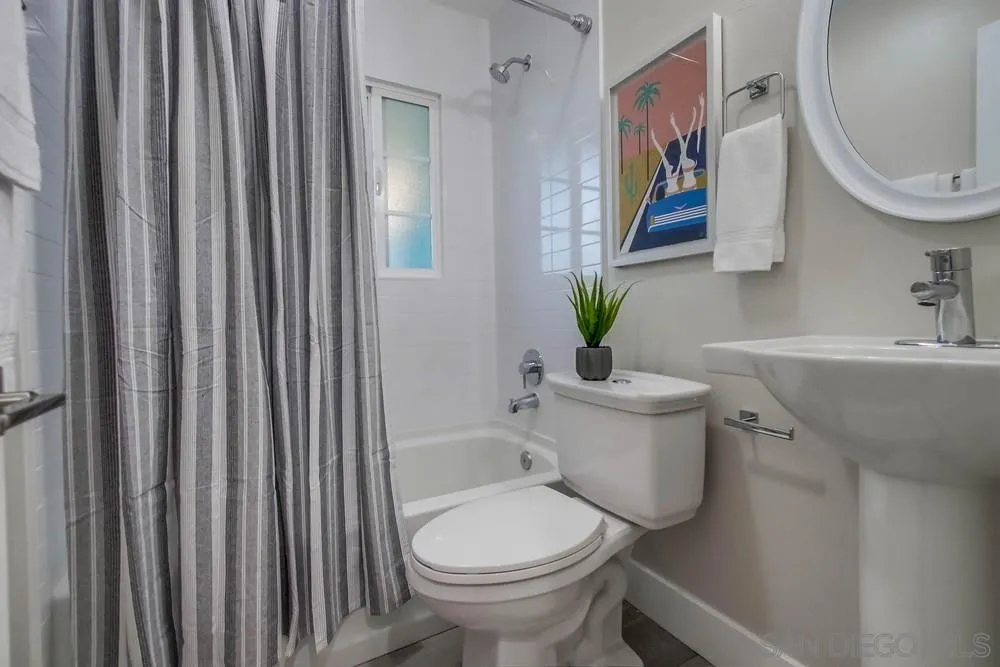 4534 Kamloop Avenue San Diego, CA 92117 - Photo 21 of 36 a bathroom with a toilet a sink and a mirror