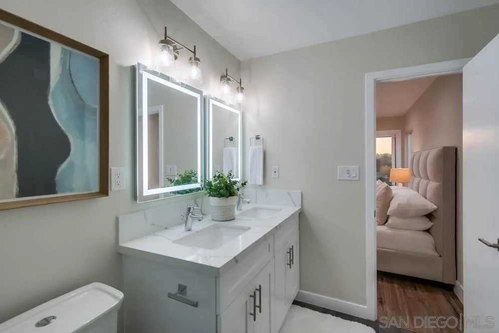 4534 Kamloop Avenue San Diego, CA 92117 - Photo 26 of 36 a bathroom with a toilet a sink and mirror