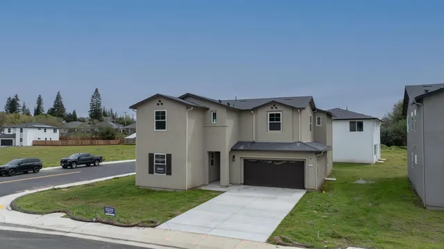 a front view of a house with a yard and garage