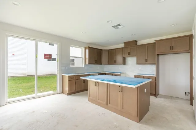a kitchen with a stove a sink and a refrigerator