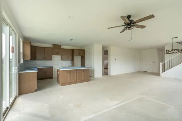 a view of a kitchen with a sink and dishwasher a refrigerator with wooden floor