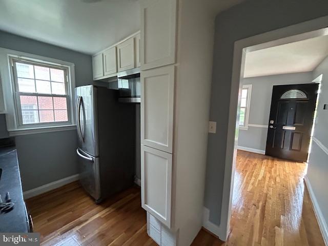 9923 Grayson Avenue Silver Spring, MD 20901 - Photo 16 of 24 a view of a refrigerator in kitchen and wooden floor
