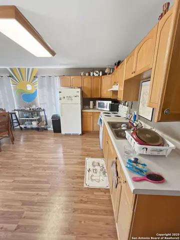 a kitchen with stainless steel appliances granite countertop a sink and a stove