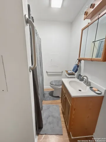 a bathroom with a sink a toilet a mirror and vanity