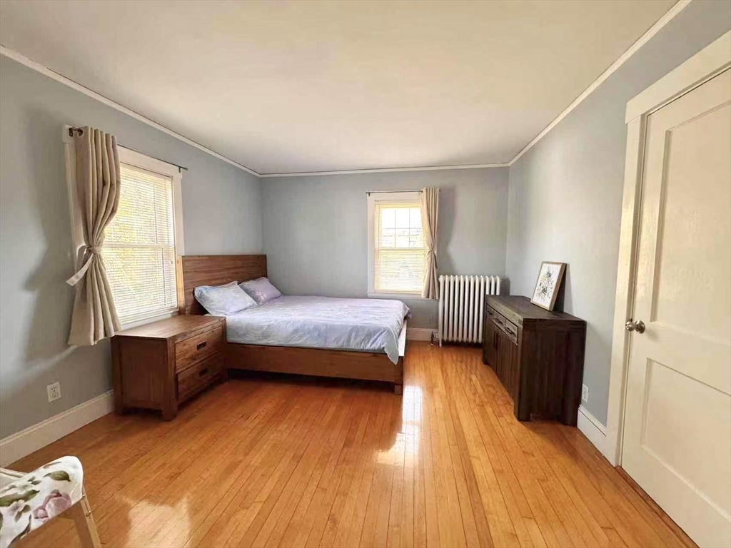 11 Sessions Street Wellesley, MA 02482 - Photo 11 of 22 a bedroom with furniture and a wooden floor