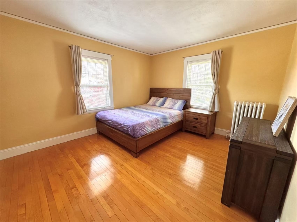 11 Sessions Street Wellesley, MA 02482 - Photo 12 of 22 a bedroom with a bed and wooden floor