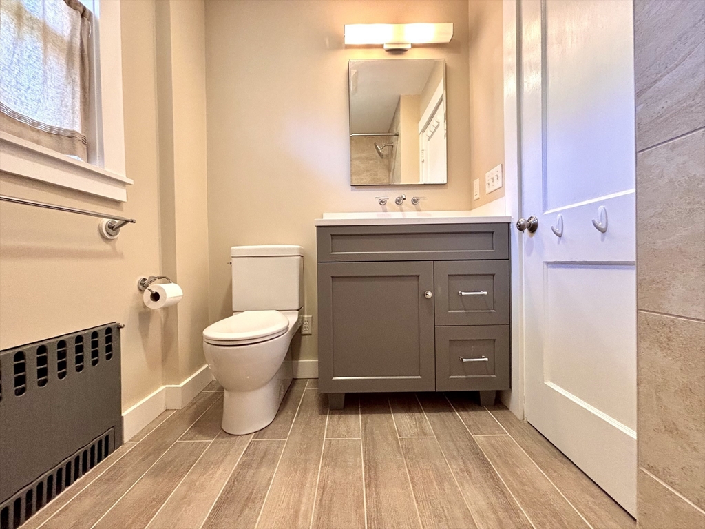 11 Sessions Street Wellesley, MA 02482 - Photo 14 of 22 a bathroom with a sink a toilet and a mirror