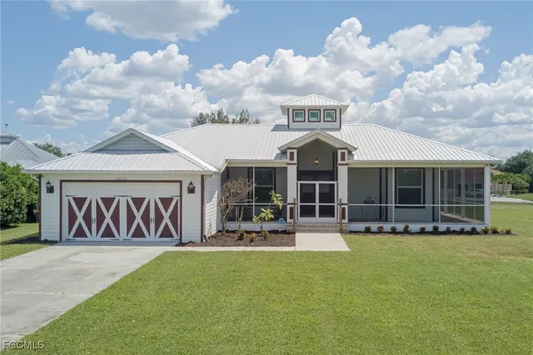 a front view of a house with garden and garage