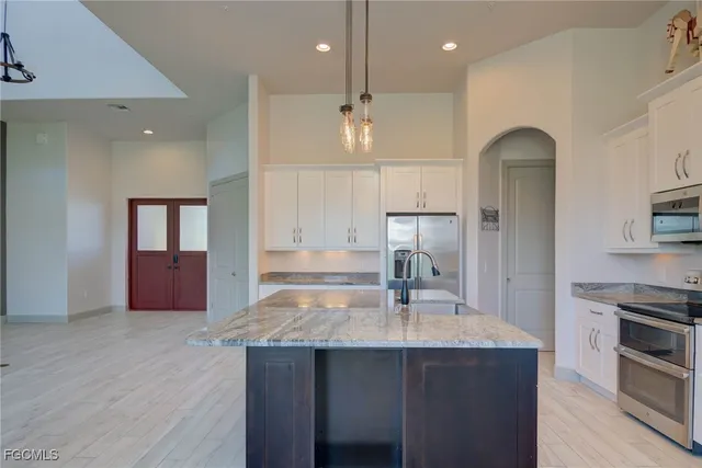 a kitchen with a sink a counter space and stainless steel appliances