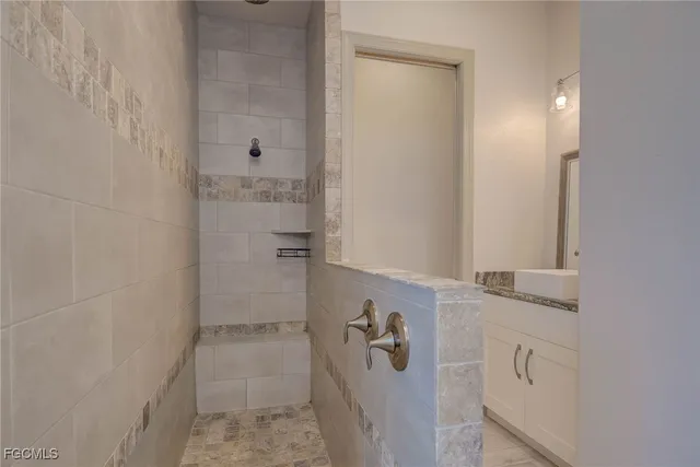 a bathroom with a granite countertop sink mirror vanity and toilet