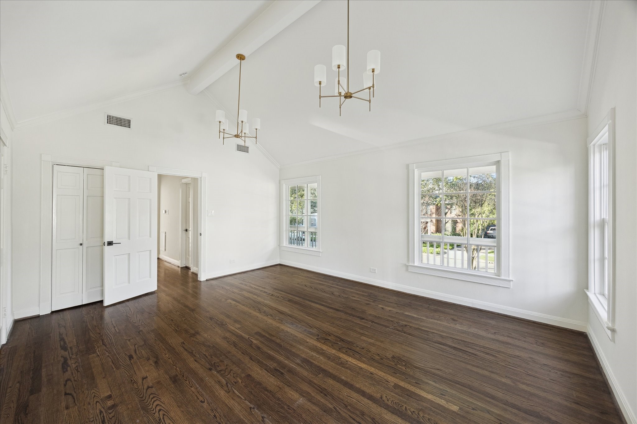 3049 Locke Lane Houston, TX 77019 - Photo 13 of 30 This incredible primary bedroom boasts gleaming hardwoods and sleek, sophisticated lighting. Extensive windows allow for serene tree-top views. Notice the door to the left is an additional closet.