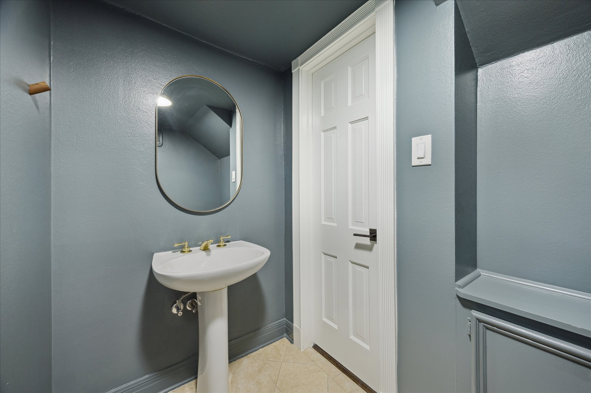 3049 Locke Lane Houston, TX 77019 - Photo 15 of 30 The downstairs powder room features fresh soft blue paint and built-in cabinetry for extra storage.