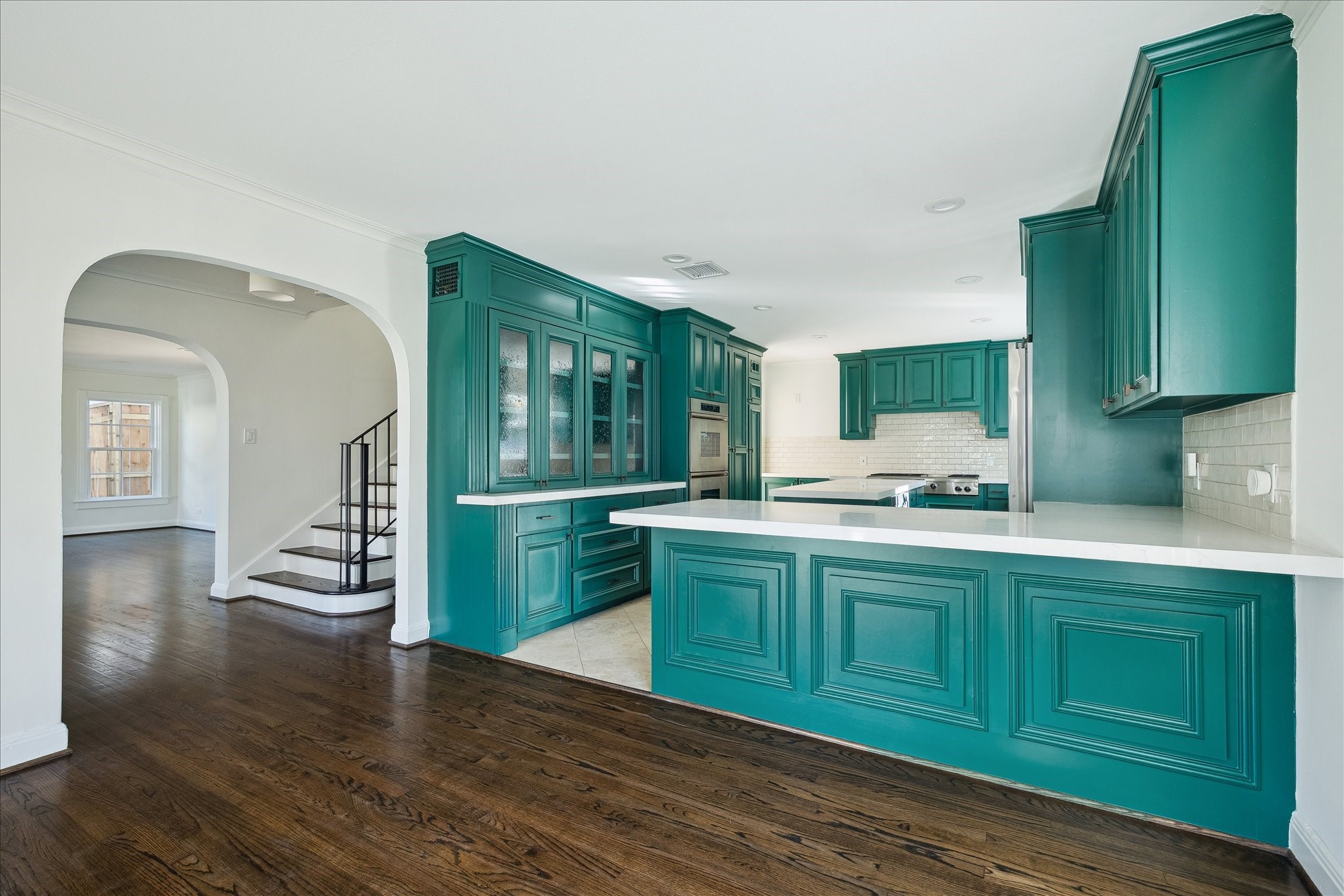 3049 Locke Lane Houston, TX 77019 - Photo 16 of 30 From this view of the immaculate kitchen, you can see how much of the vast space can be utilized for preparing meals. An abundance of storage space is provided from sleek cabinetry while recessed lighting and travertine floors add to the sophistication of this kitchen.