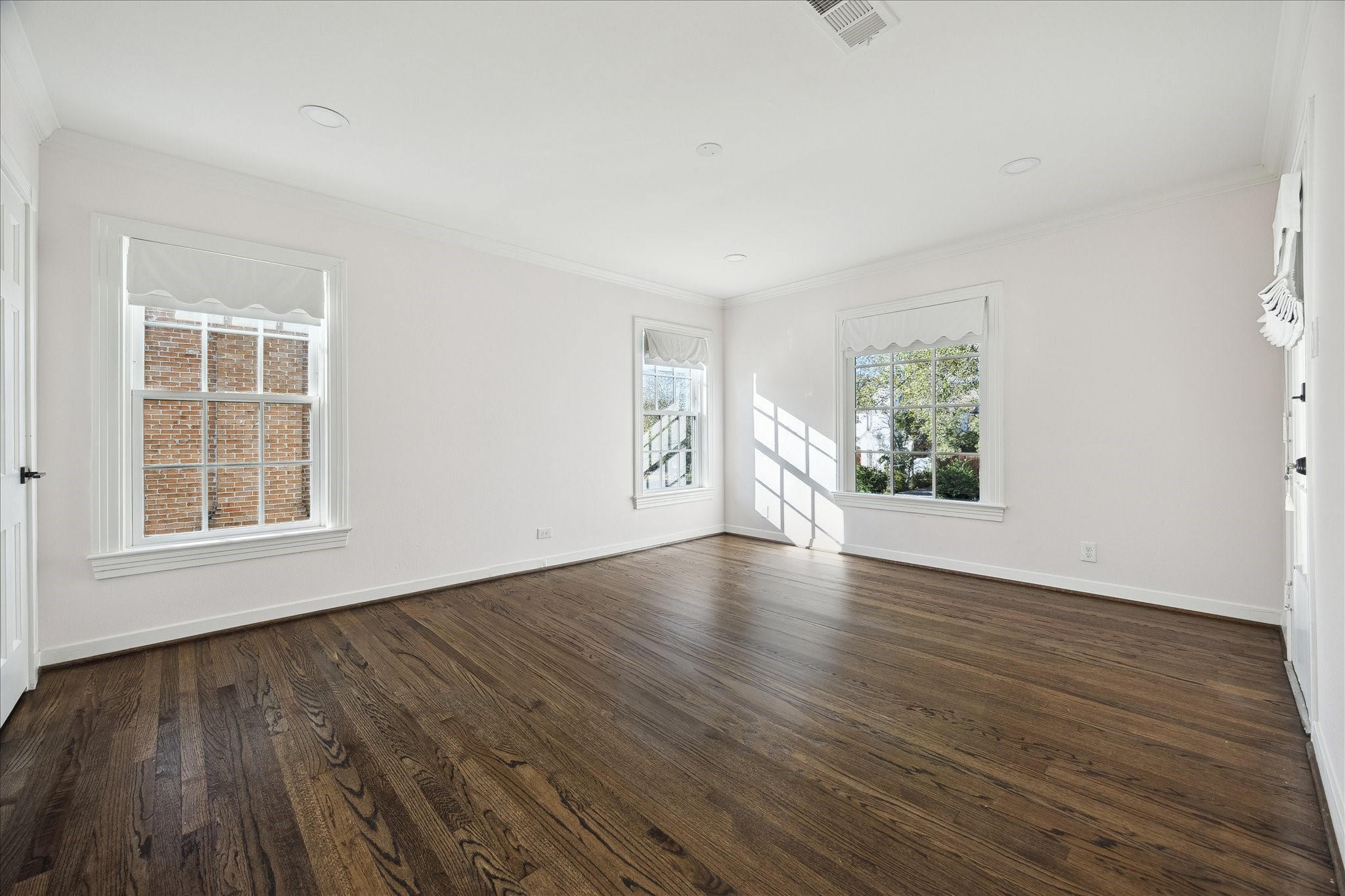 3049 Locke Lane Houston, TX 77019 - Photo 23 of 30 The walls of this spacious secondary are wrapped by large windows allowing for the ultimate tree-top views, with access to the second-floor balcony.