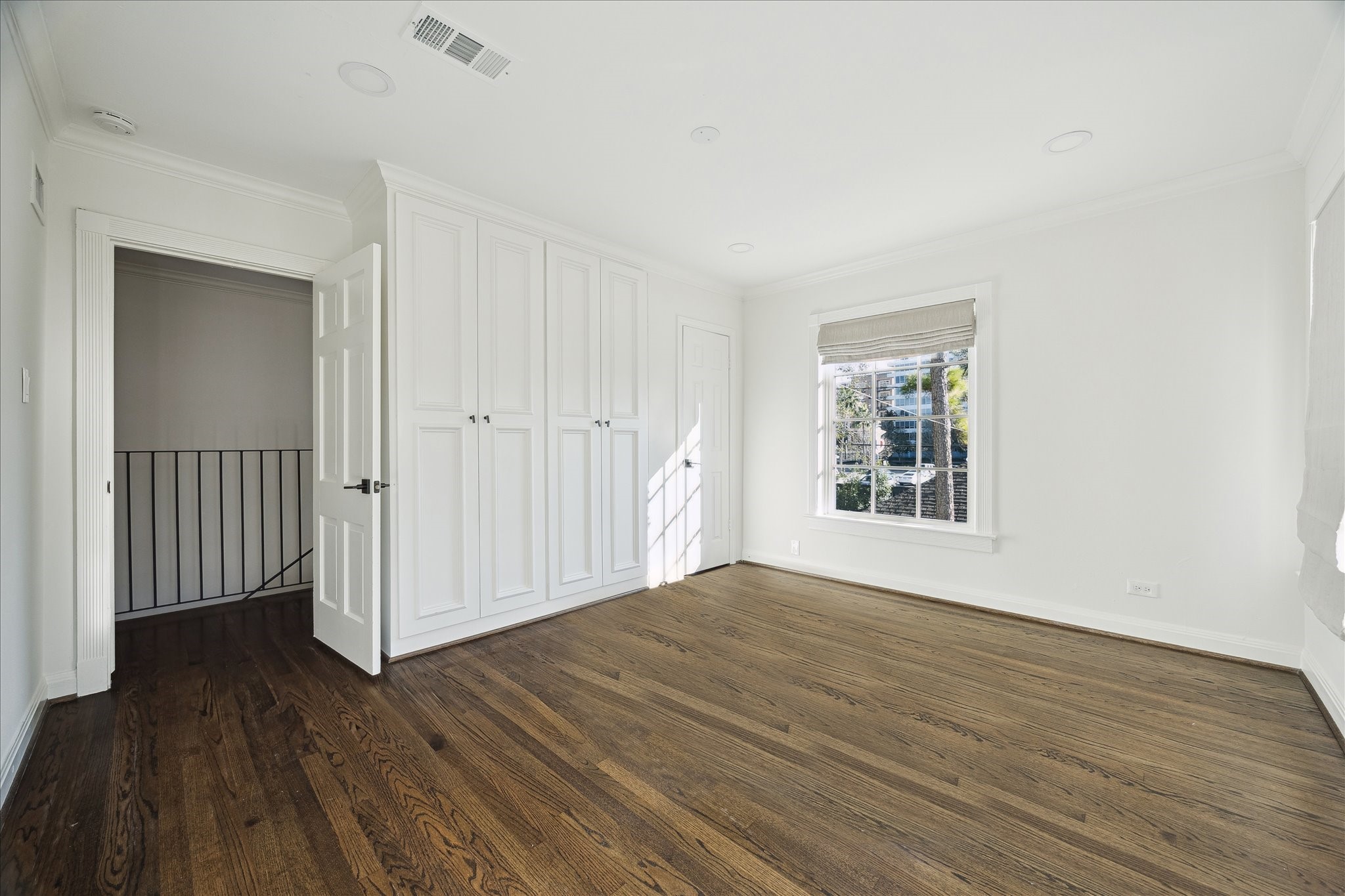 3049 Locke Lane Houston, TX 77019 - Photo 25 of 30 This light and bright bedroom is the first of two secondary bedrooms. The room features tons of built-in storage and views of the grassy backyard.