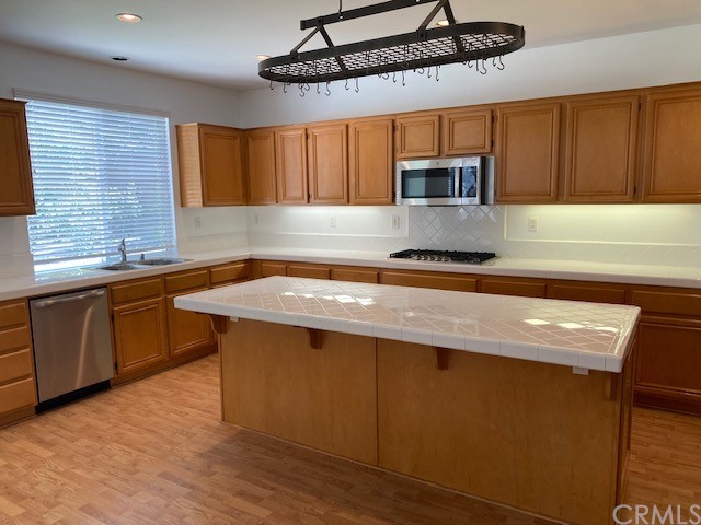 65 Ashford Irvine, CA 92618 - Photo 11 of 45 a kitchen with stainless steel appliances granite countertop a sink a stove counter space and cabinets