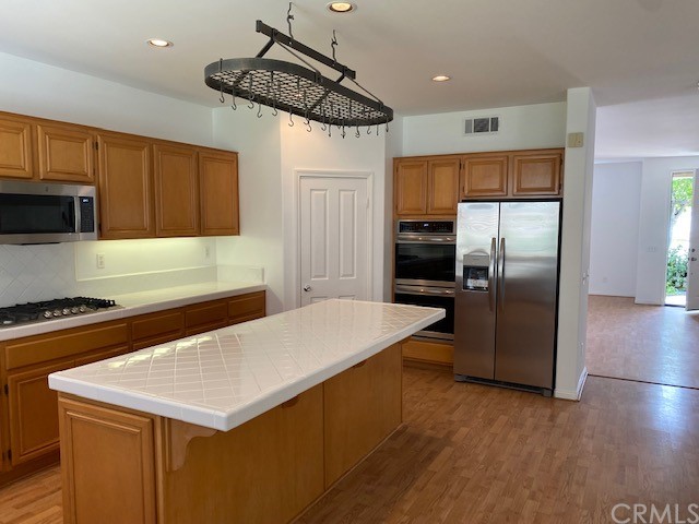 65 Ashford Irvine, CA 92618 - Photo 12 of 45 a kitchen with a refrigerator a sink and cabinets