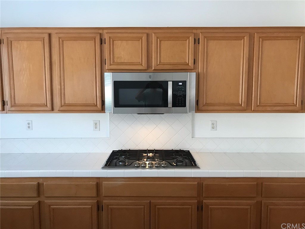 65 Ashford Irvine, CA 92618 - Photo 4 of 45 a kitchen with granite countertop cabinets and a stove top oven
