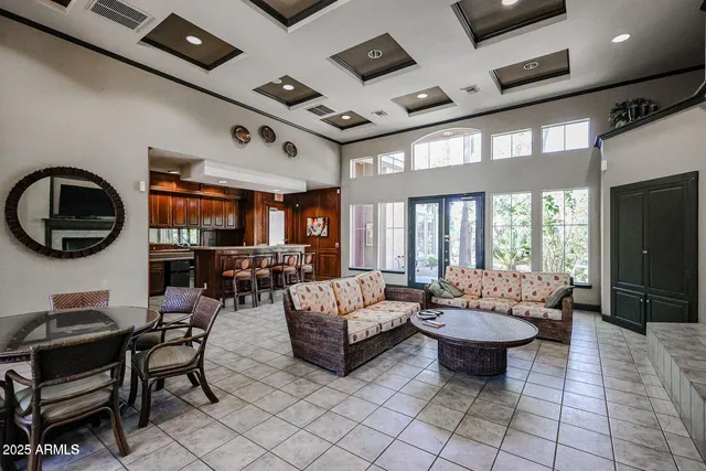 a living room with patio furniture and a flat screen tv