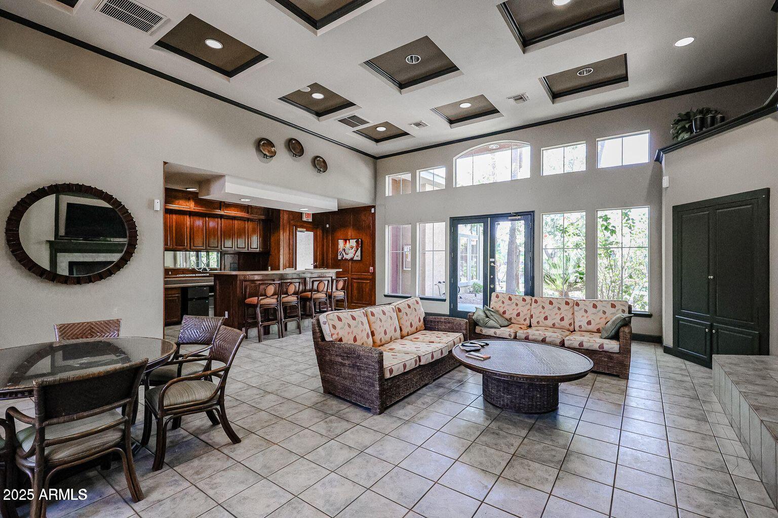 5401 East Van Buren Street, Unit 1027 Phoenix, AZ 85008 - Photo 16 of 23 a living room with patio furniture and a flat screen tv