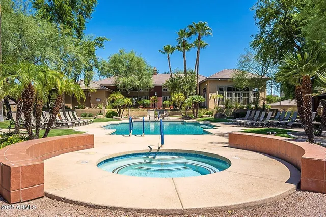 a swimming pool with outdoor seating and yard