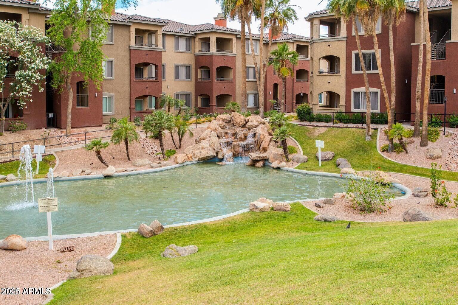 5401 East Van Buren Street, Unit 1027 Phoenix, AZ 85008 - Photo 19 of 23 a view of a house with a yard