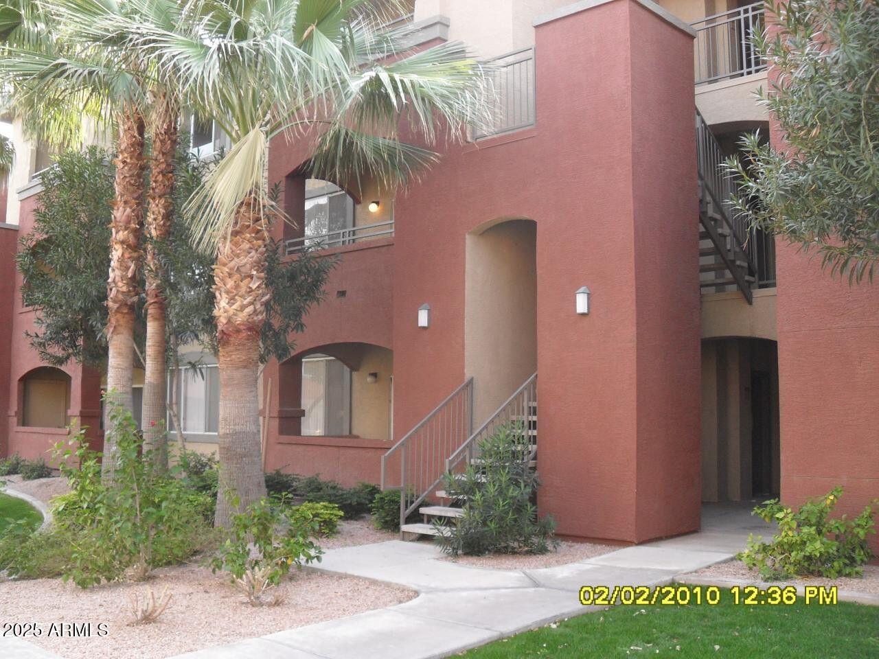 5401 East Van Buren Street, Unit 1027 Phoenix, AZ 85008 - Photo 2 of 23 a front view of a house with garden