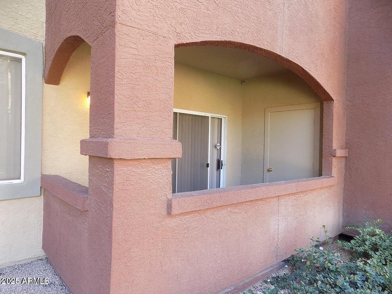 5401 East Van Buren Street, Unit 1027 Phoenix, AZ 85008 - Photo 22 of 23 a front view of a house with entryway