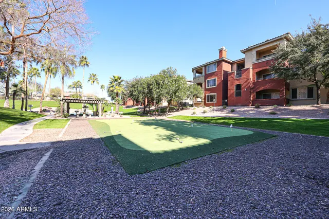 a swimming pool with outdoor seating and yard