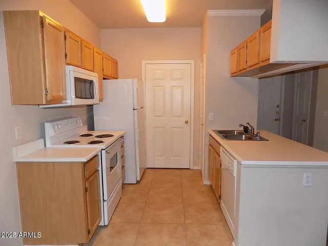 a kitchen that has a sink and a stove
