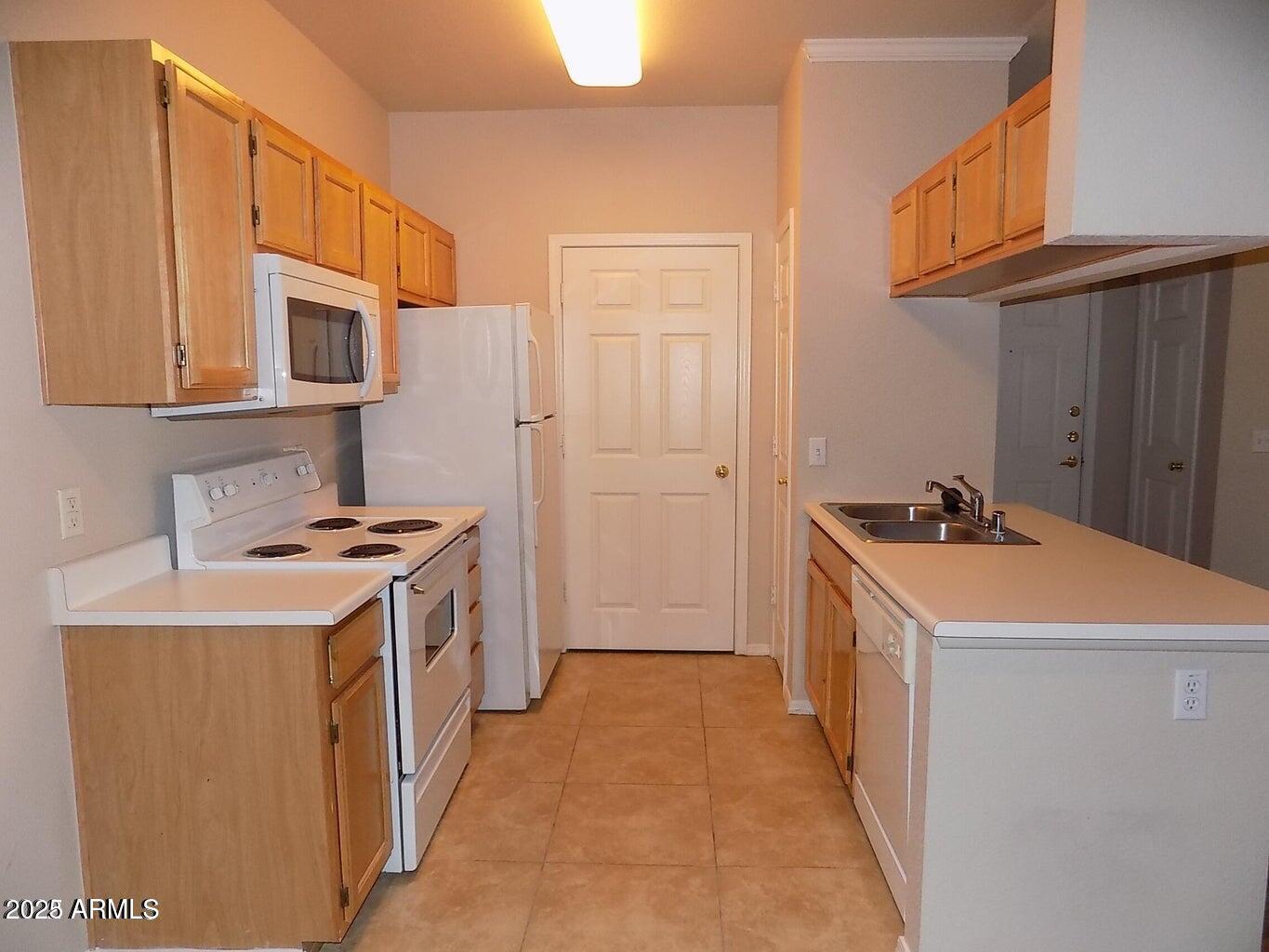 5401 East Van Buren Street, Unit 1027 Phoenix, AZ 85008 - Photo 7 of 23 a kitchen that has a sink and a stove