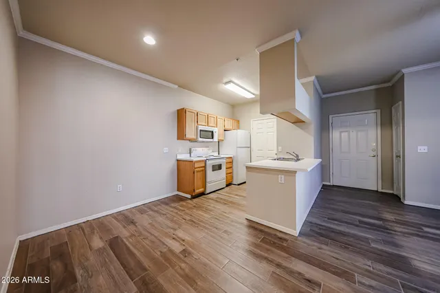 a view of a room with wooden floor and ceiling fan