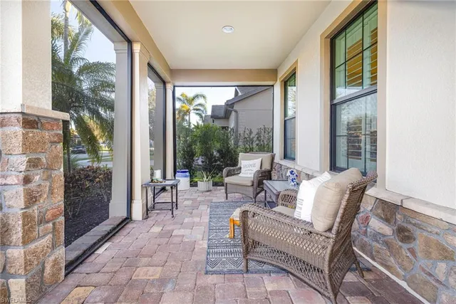 a living room with furniture and large windows