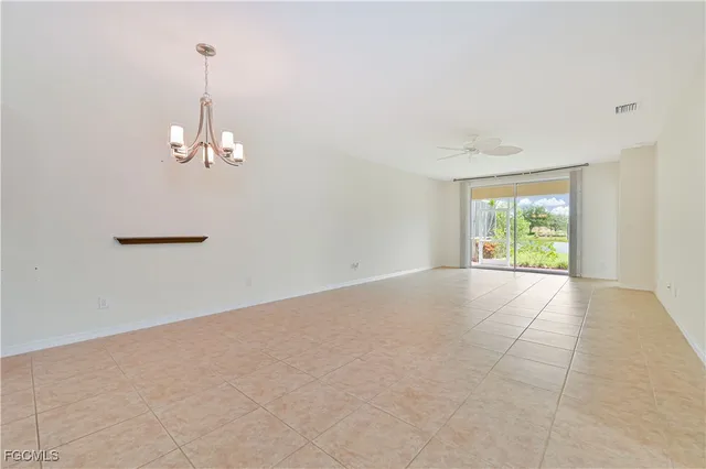 a view of a kitchen with a sink and chandelier