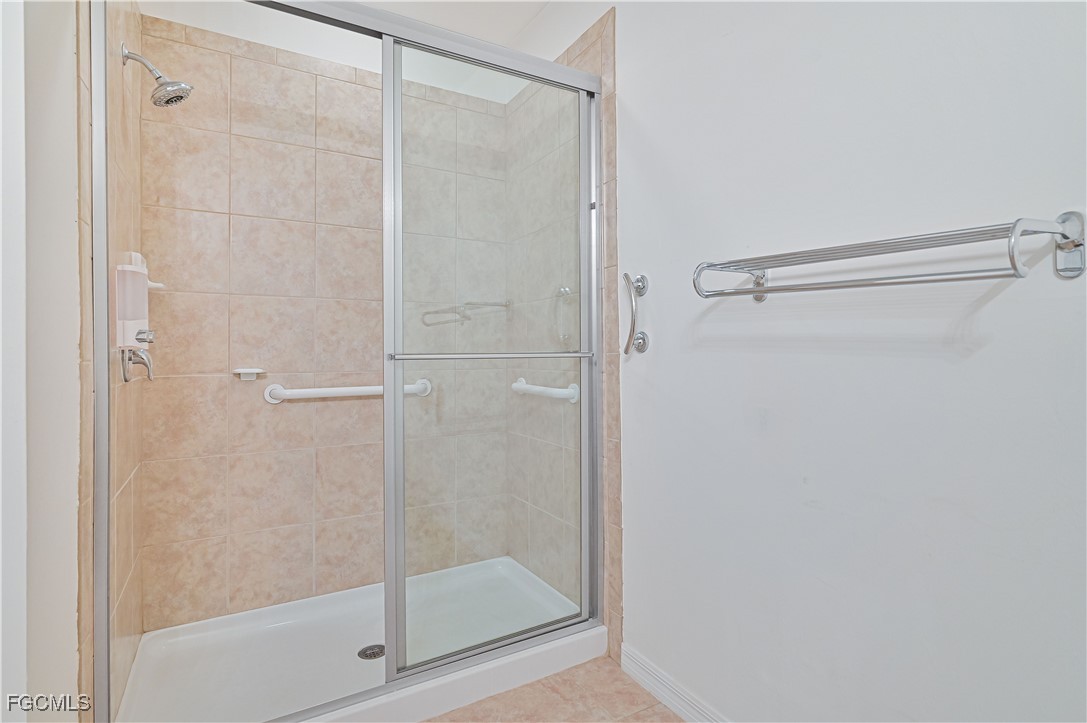 15239 Ligustrum Lane Alva, FL 33920 - Photo 30 of 44 a bathroom with a glass shower door
