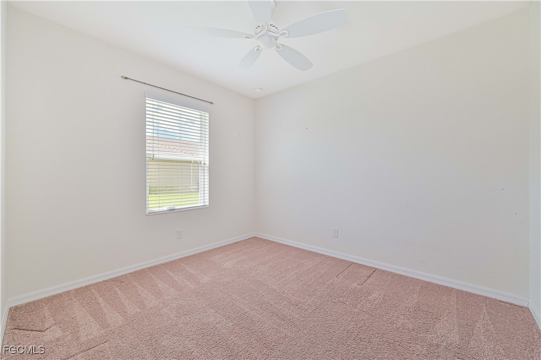 15239 Ligustrum Lane Alva, FL 33920 - Photo 32 of 44 an empty room with windows and fan