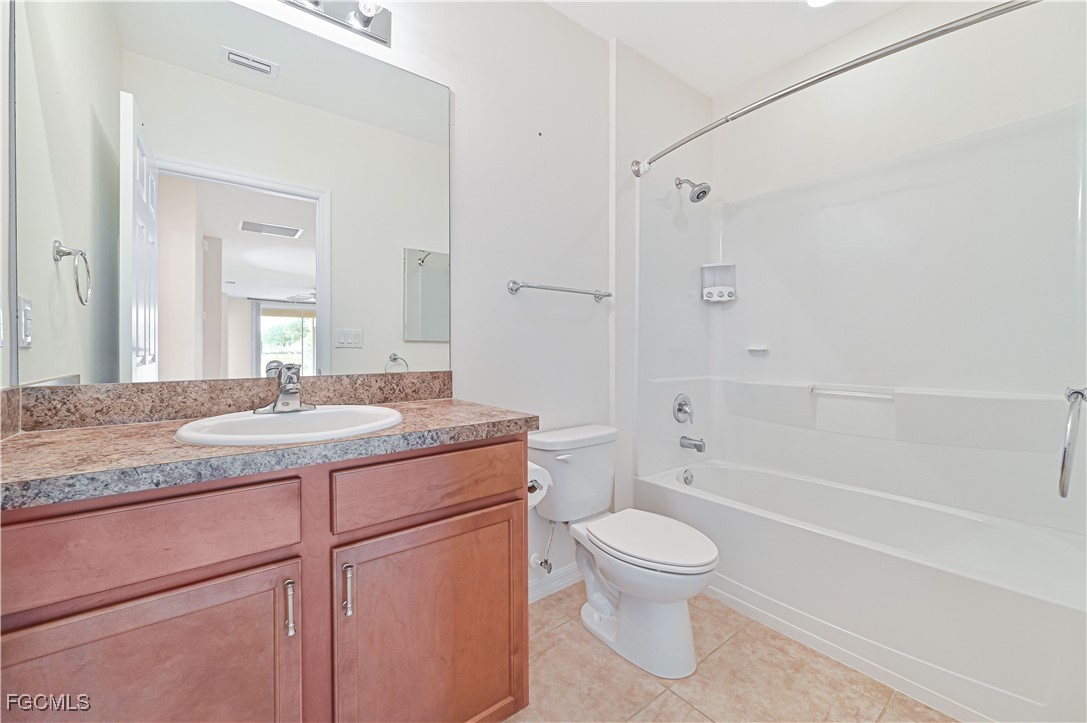 15239 Ligustrum Lane Alva, FL 33920 - Photo 34 of 44 a bathroom with a granite countertop toilet a sink and a bathtub